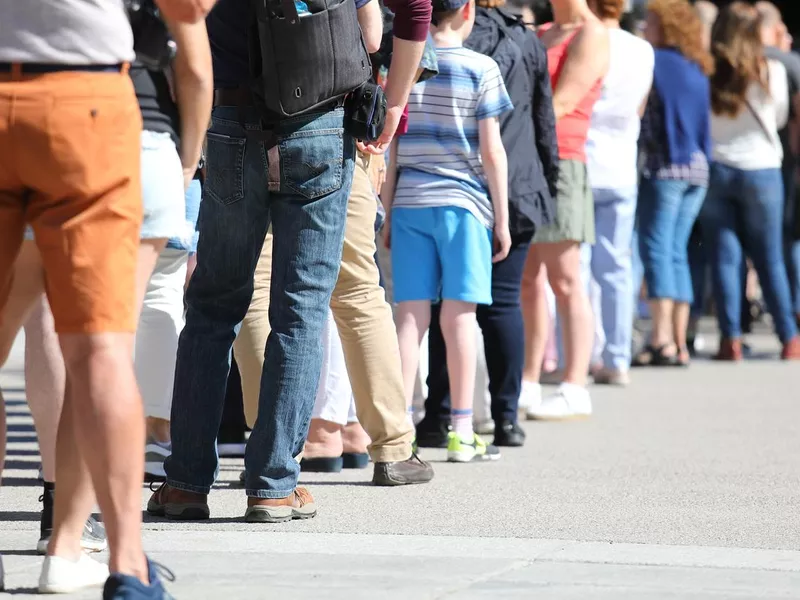 Long queue of people waiting in line
