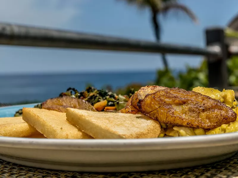 Jamaican breakfast of bammy, plantain, ackee and sailfish, and callaloo
